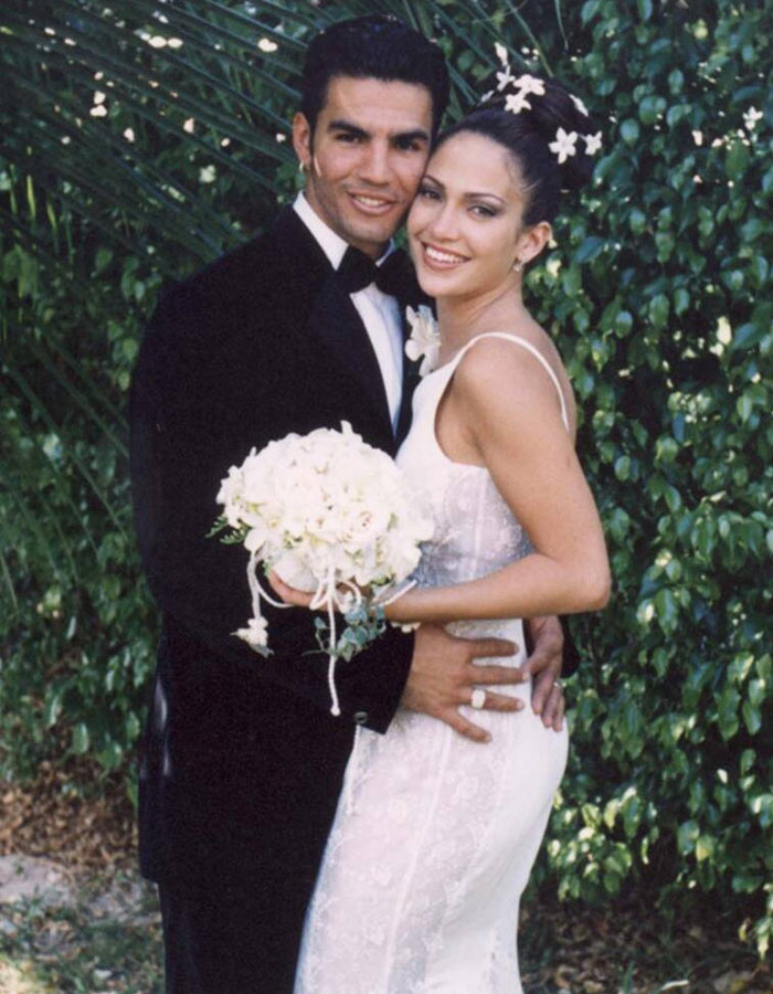 Jennifer Lopez opts for a big bun with white flowers at her first wedding.