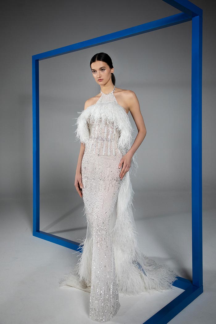 SS21-8-Off-white-halter-neck-gown-embroidered-with-crystals-and-beads-featuring-a-backless-cape-highlighted-with-a-border-of-ostrich-feathers